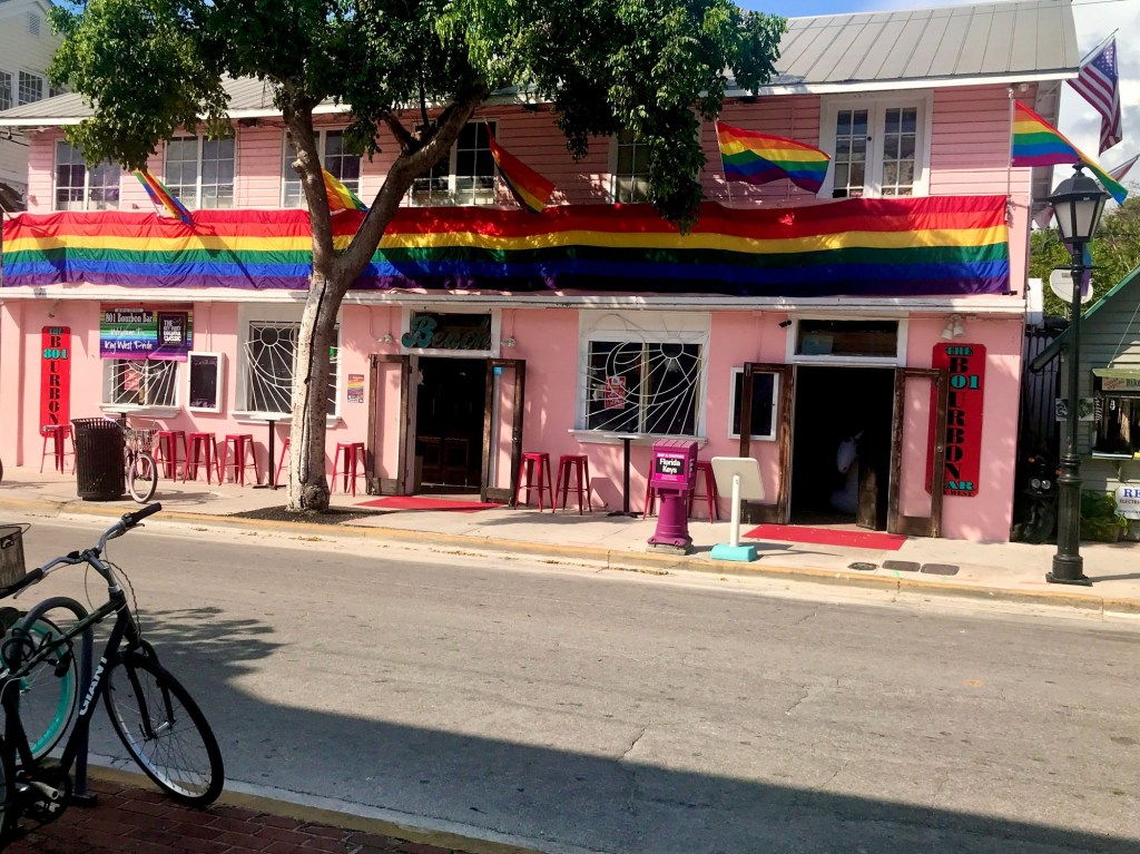 Picture of a colorful building draped in Pride flags in Key West, Florida