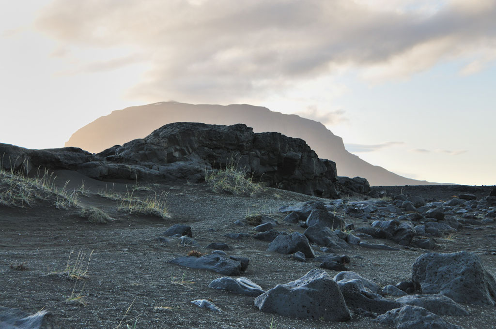 Dark grey rocky landscape under soft morning light