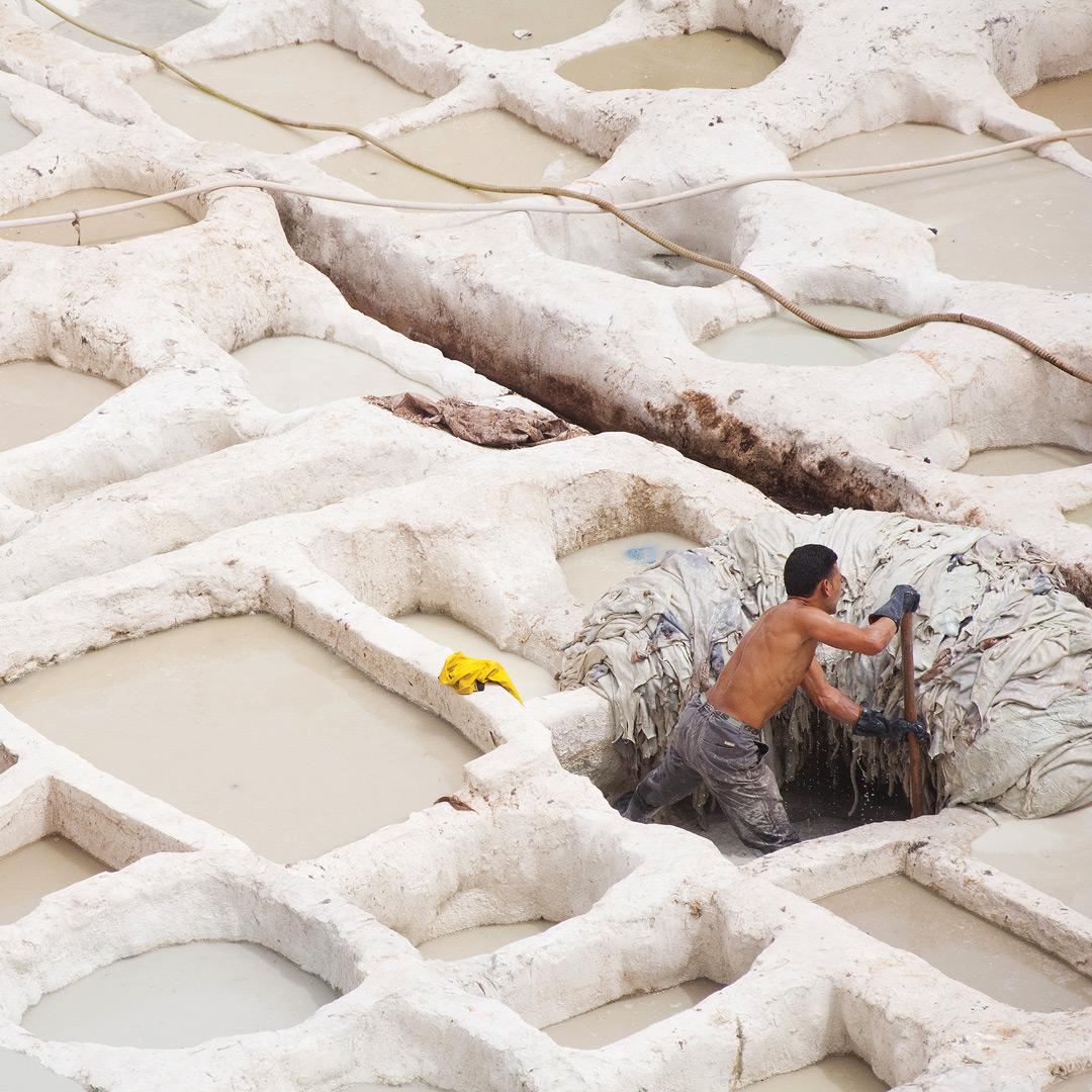 a man works in a tannery in Morocco