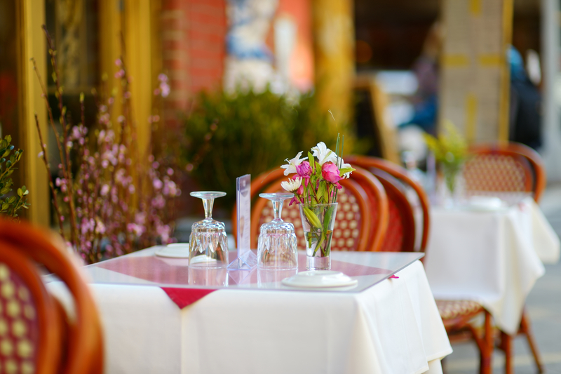 Image of charming table set up on the sidewalk outside of a restaurant.