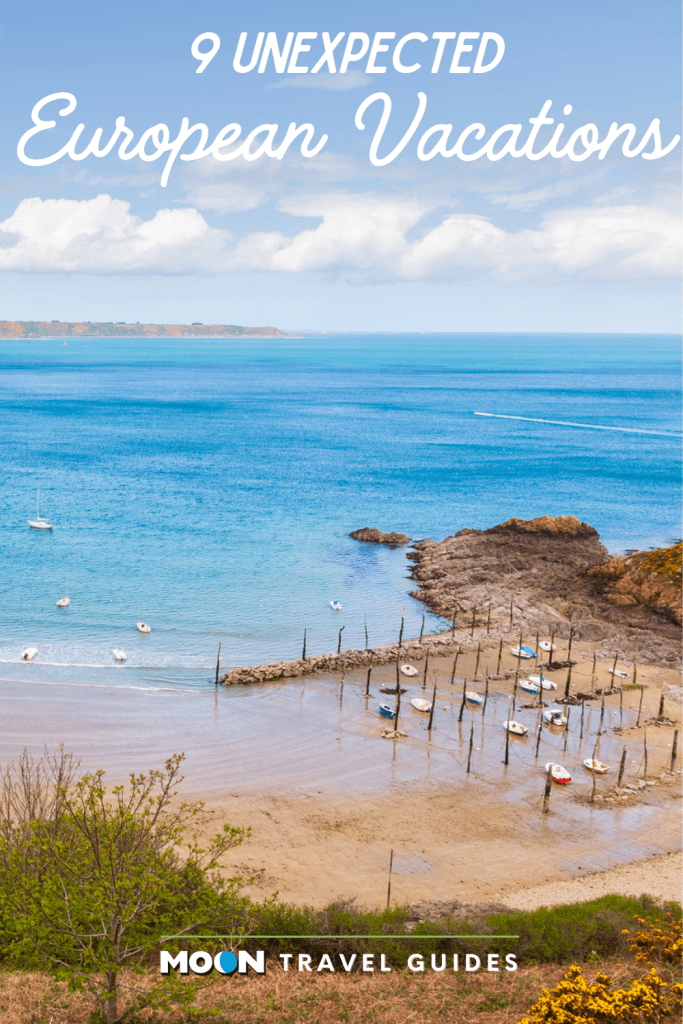 Image of quaint boat harbor in sandy cove with text 9 Unexpected European Vacations