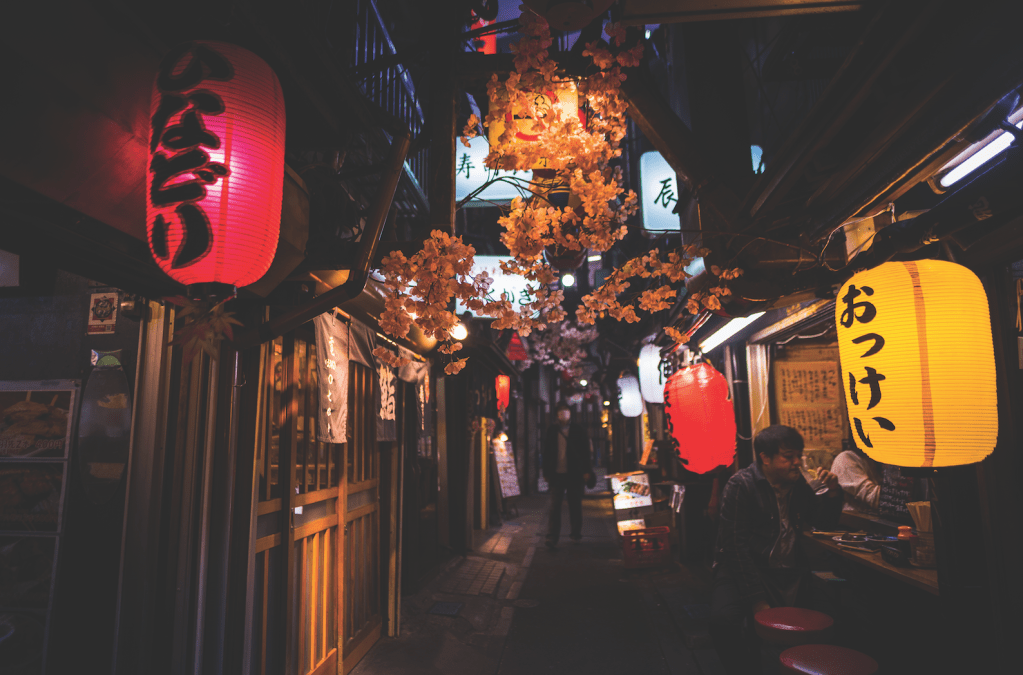 view of lanterns hanging outside of restaurant doorways at night Yakitori Alley